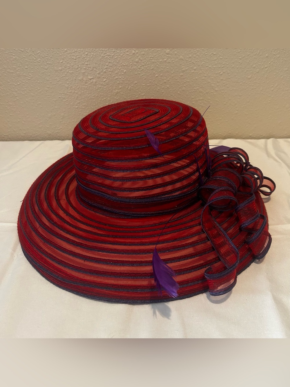 Elegant Red Wide-Brim Dress Hat with Purple Feather Trim